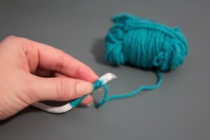 An image of the beginning of a coiled rope and yarn basket. 