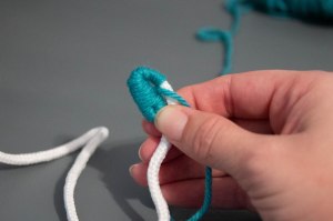 An image of the making of a coiled rope and yarn coaster. 