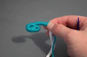 An image of the beginning of a coiled rope and yarn basket. 