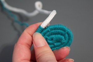 An image of the making of a coiled rope and yarn coaster. 