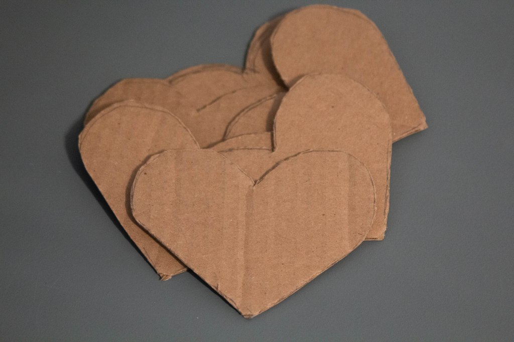Three inch hearts cut out of cardboard.
